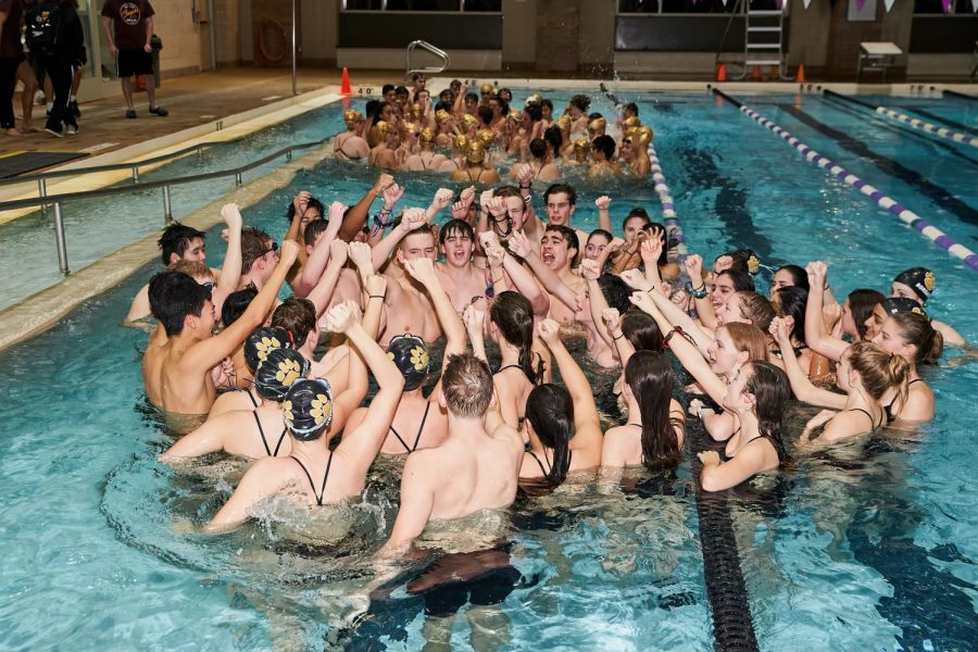 The swim team rallying together before their meet against Oakton.