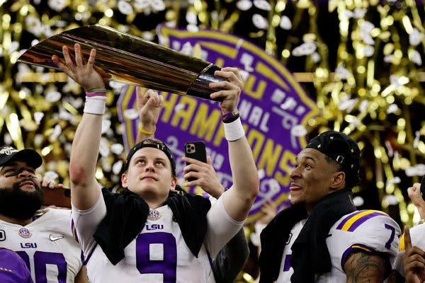 Joe Burrow holding the national championship trophy after beating Clemson 42-25.