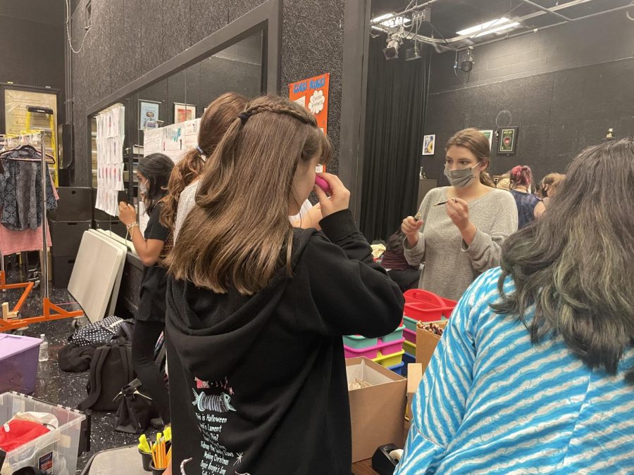 Actors getting makeup put on for a dress rehearsal.  