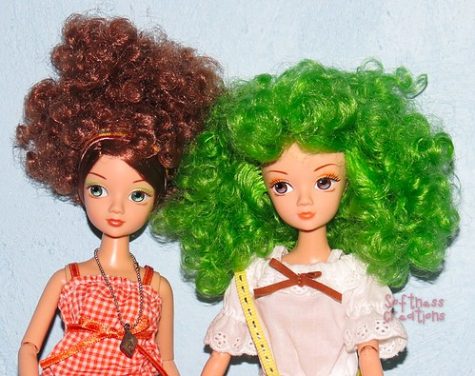 Two dolls with curly hair.