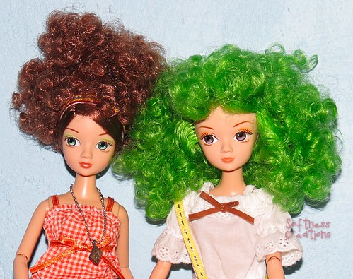 Two dolls with curly hair.