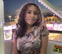 A picture of Stephanie on a ferris wheel. 